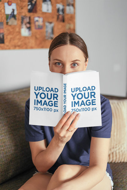 Mockup of a Woman Holding a Book Close to Her Face