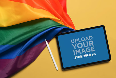 Mockup of an iPad Pro Placed Next to a Gay Pride Flag m27498 r-el2