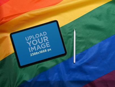 Mockup of an iPad Pro Placed over a Rainbow LGBTQ Pride Flag m16981 r-el2