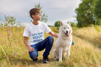 Round-Neck Tee Mockup of a Boy with Glasses Posing with His Dog