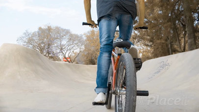 Dude Riding a BMX Bike While Wearing a Snapback Hat Backward in a Skatepark Video Mockup a14191