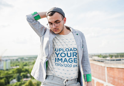 Heathered T-Shirt Mockup of a Stylish Man Posing With a Gray Suit