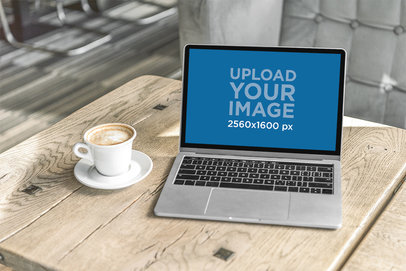 MacBook Mockup Featuring a Coffee Cup and a Rustic Wooden Table m18650 r-el2