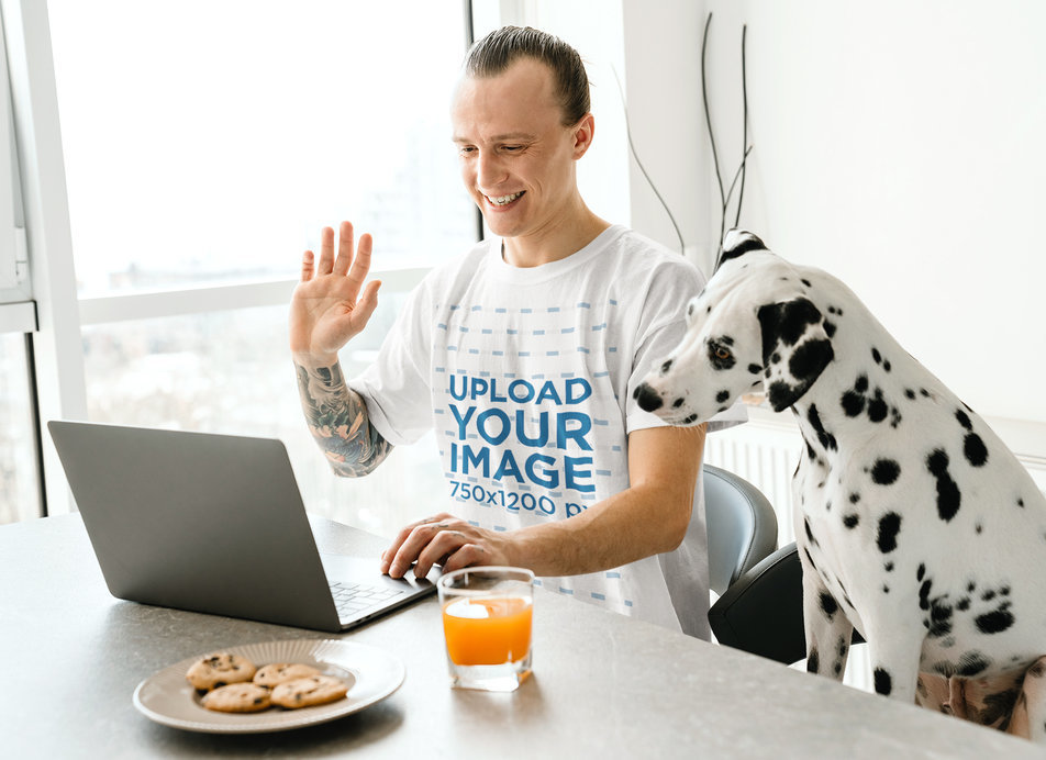 Heathered T-Shirt Mockup Featuring a Man Doing a Video Conference With His Dog