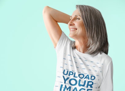 T-Shirt Mockup Featuring a Smiling Senior Woman Against a Colorful Background