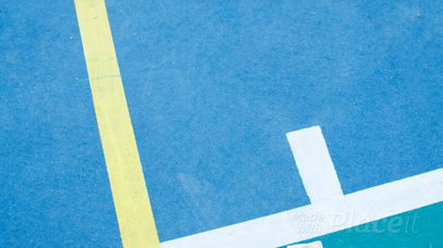 Volleyball Jersey Maker - Folded Jersey Lying on a Court Near a Volleyball