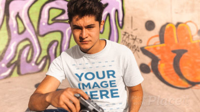 Young Man with a Vintage Camera Wearing a T-Shirt Stop Motion at a Skating Park