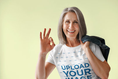 T-Shirt Mockup of a Happy Senior Woman Posing With a Denim Jacket on Her Back m25799 r-el2