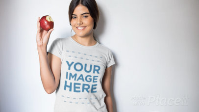 Video of a Beautiful Woman Eating an Apple Wearing a T-Shirt