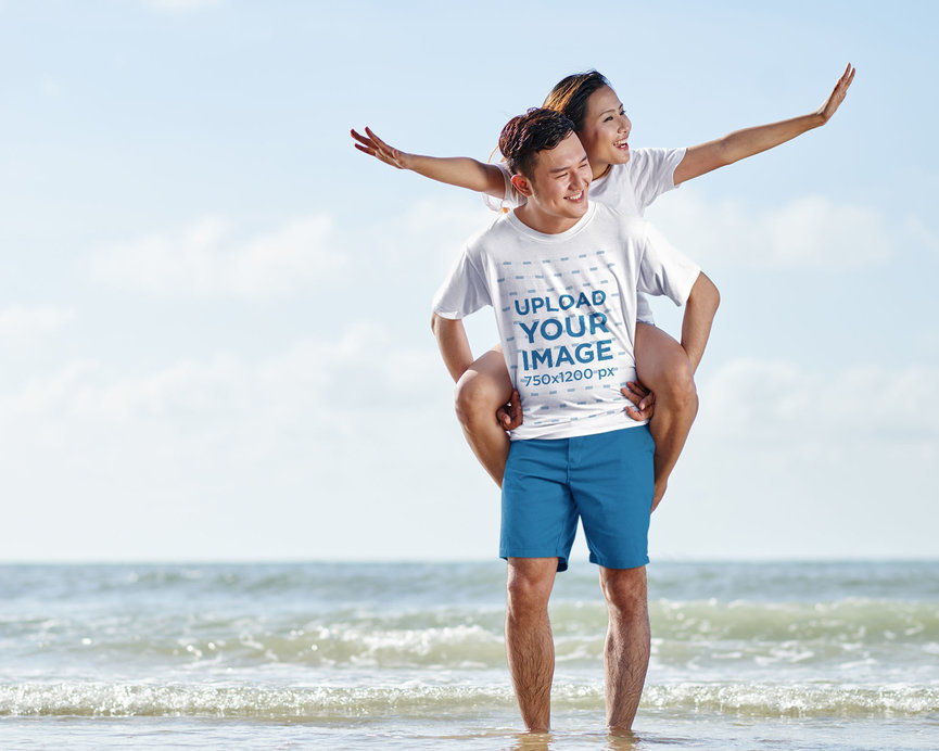 Tee Mockup of a Man Carrying His Wife by the Beach