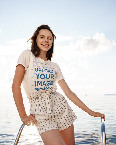 Basic T-Shirt Mockup of a Happy Woman in a Summer Outfit Posing by the Sea