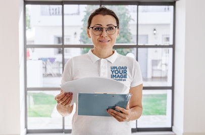 Heathered Polo Shirt Mockup of a Female Teacher with Glasses Holding Papers