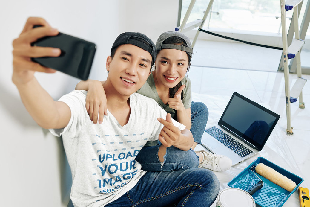Heathered T-Shirt Mockup of a Man Taking a Selfie With a Friend