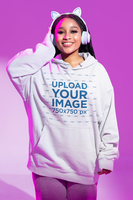 Mockup of a Woman With Kitty Headphones Wearing an Oversized Hoodie 