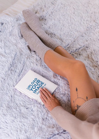 Mockup of a Woman with a Leg Tattoo with a Book on Her Hand