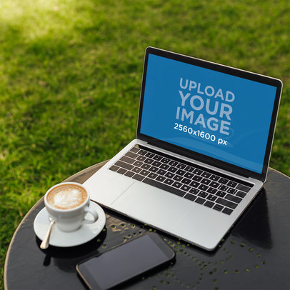 Mockup of a MacBook on an Outdoor Coffee Table