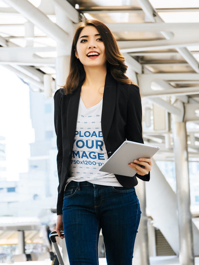 T-Shirt Mockup of a Woman Walking in an Airport