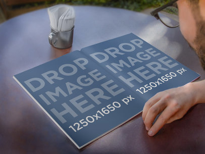 Outside Reading a Magazine Mockup of Young Man With Glasses