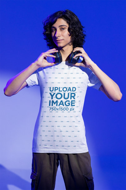 Tee Mockup of a Gamer Man Grabbing His Headphones at a Studio