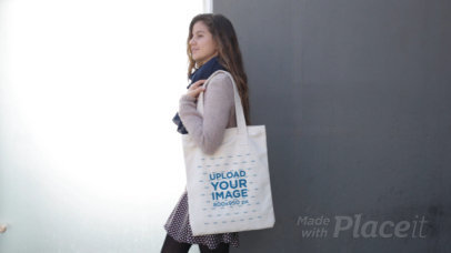 Beautiful Girl Carrying a Tote Bag Video While Lying Against a Black and White Wall a13766