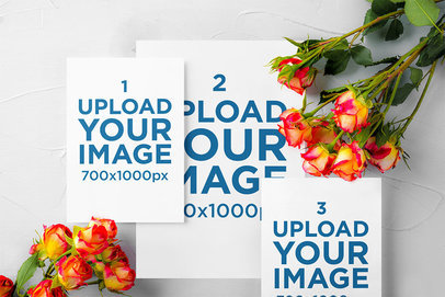 Mockup of Three Wedding Programs With Some Flowers Around Them