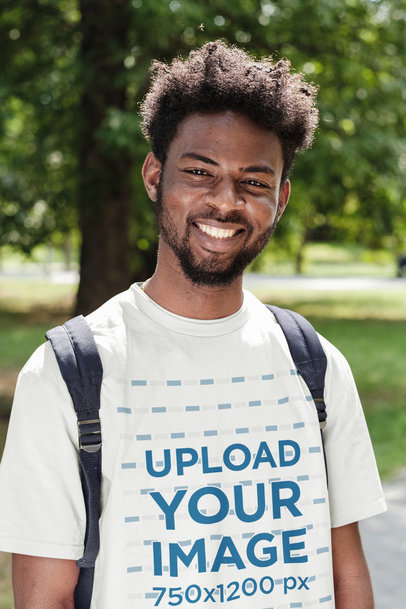 T-Shirt Mockup Featuring a Happy Man With a Backpack