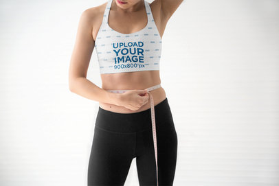 Sports Bra Mockup of a Cropped-Face Woman Using a Measuring Tape m21612 r-el2
