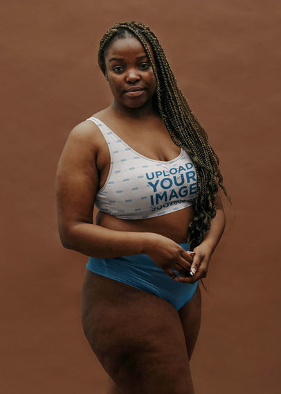 Sports Bra Mockup Featuring a Woman Posing With a Serious Look