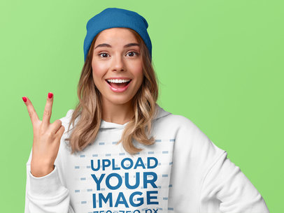 Pullover Hoodie Mockup of a Cheerful Woman Standing in a Studio