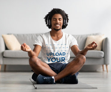 Heathered Tee Mockup of a Man Meditating with Headphones On
