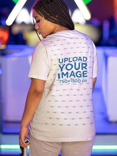 Back-View Mockup of a Woman Wearing a Tee at a Gamers Arena