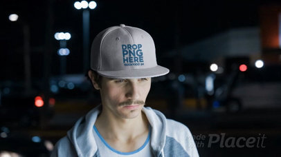 Young White Man Wearing a Snapback Hat Video in the City at Night