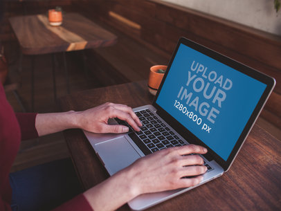 MacBook Mockup Being Used on a Wooden Desk