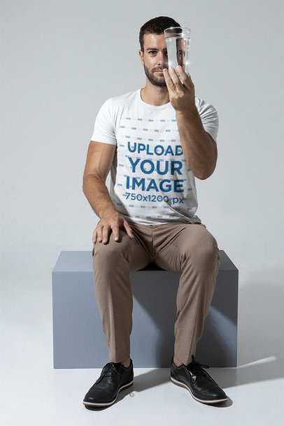 Bella Canvas Tee Mockup of a Man Holding a Glass of Water In Front of Him m28421