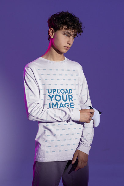 Bella Canvas Long-Sleeve Tee Mockup Featuring a Gamer Posing at a Studio