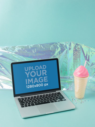 MacBook Mockup on a Light Blue Desk Near a Plastic Ice Cream a19500