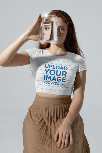 Mockup of a Woman Wearing a Crop Top and Holding a Vase With Water m28397
