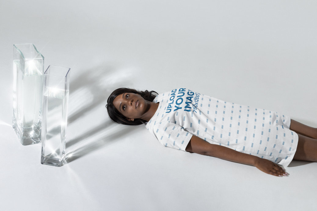 Mockup of a Woman Lying on the Floor With a T-Shirt Dress