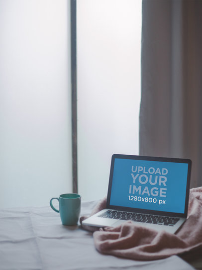 MacBook Pro Mockup on the Bed Near a Window