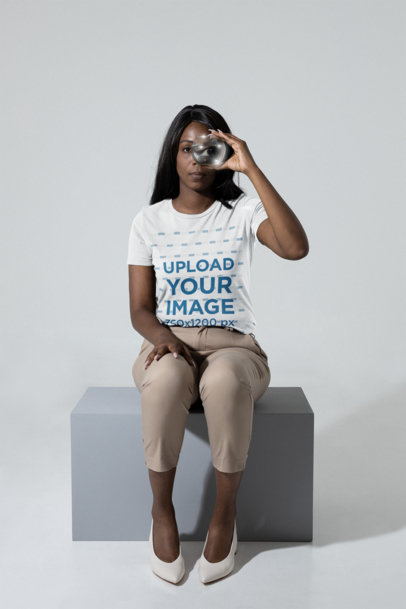 T-Shirt Mockup of a Woman Looking Through a Fishbowl at a Studio m28406