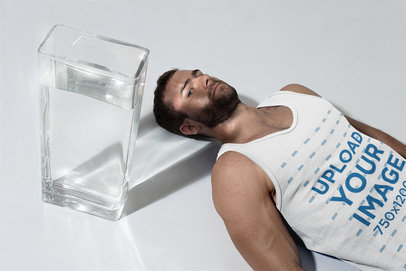 Tank Top Mockup of a Man Lying Next to a Glass Vase with Water
