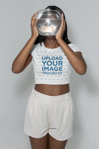 Mockup of a Woman Wearing a Crop Top and Holding a Fishbowl to Her Face m28402