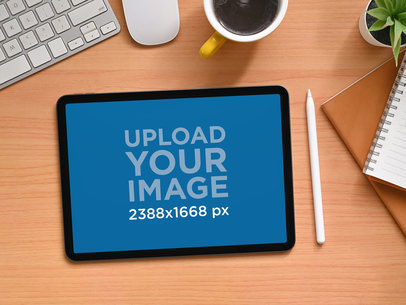 Mockup of an iPad Placed Over a Wooden Table Featuring a Keyboard and a Notebook m16146 r-el2