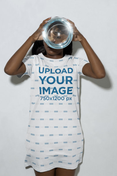 Mockup of a Woman Holding a Fish Bowl and Wearing a T-Shirt Dress