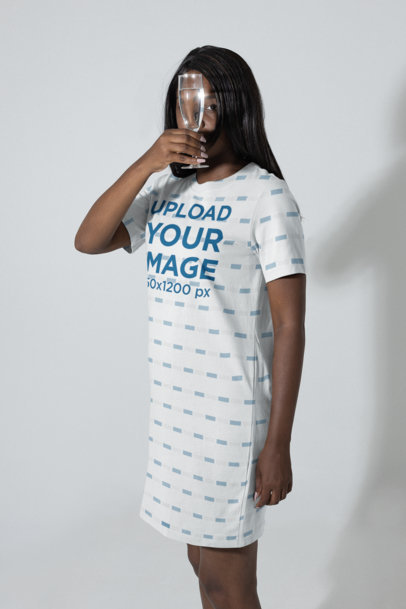 T-Shirt Dress Mockup Featuring a Woman Looking Through a Glass