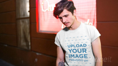 Hipster Man Wearing a Round Neck Tee Video Outside a Store at Night