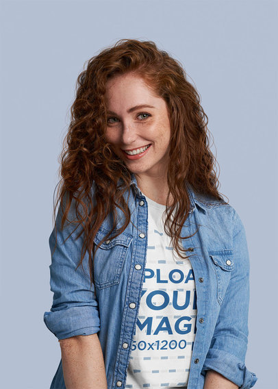 T-Shirt Mockup of a Redheaded Woman at a Studio Making a Shy Smile
