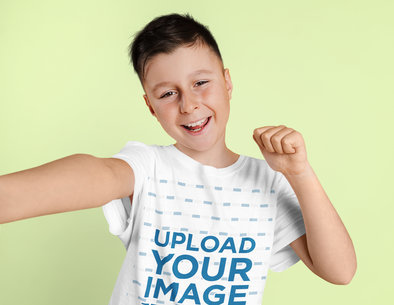 T-Shirt Mockup Featuring a Happy Kid Taking a Selfie