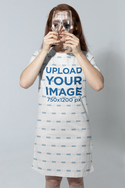 Mockup of a Woman With a T-Shirt Dress Holding Two Glasses 