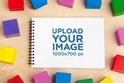 Mockup of a Notebook Placed Around Some Colored Cubes m28733 r-el2